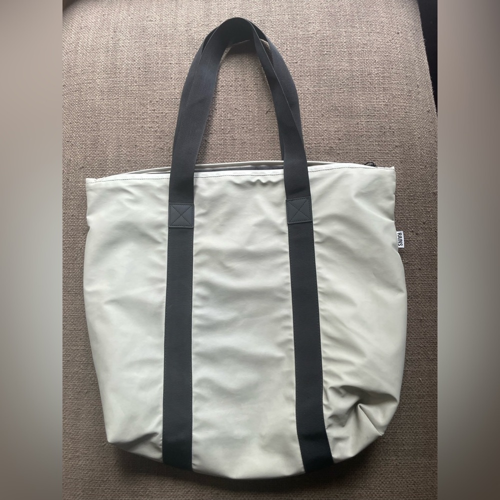 Rains Cream and Black Duffel Bag